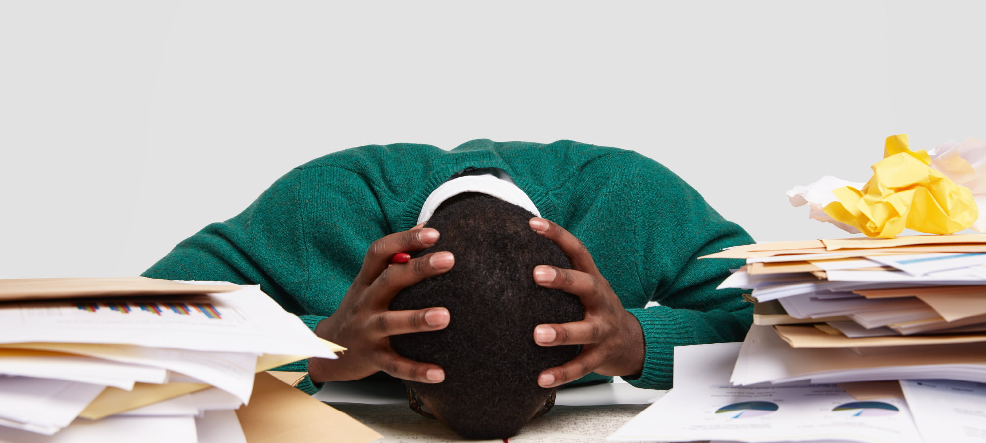 Personne stressée entourée de papiers administratifs après la perte de son emploi